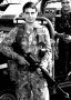 Airforce Association NSW 2AFDS photo gallery - 1992 - LAC Steve Patterson and LAC John Zyzniewski of Support Flight, No. 2 Airfield Defence Squadron (2AFDS) on the tarmac at RAAF Base Amberley. LAC Patterson is armed with an M16A1 fitted with a Blank Firing Attachment (BFA), while LAC Zyzniewski is se